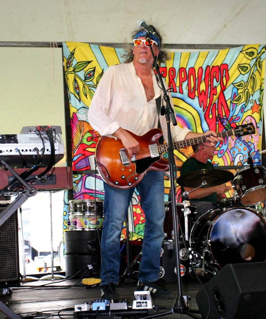 Base player from St. Pete Sons performing live on the festival stage.